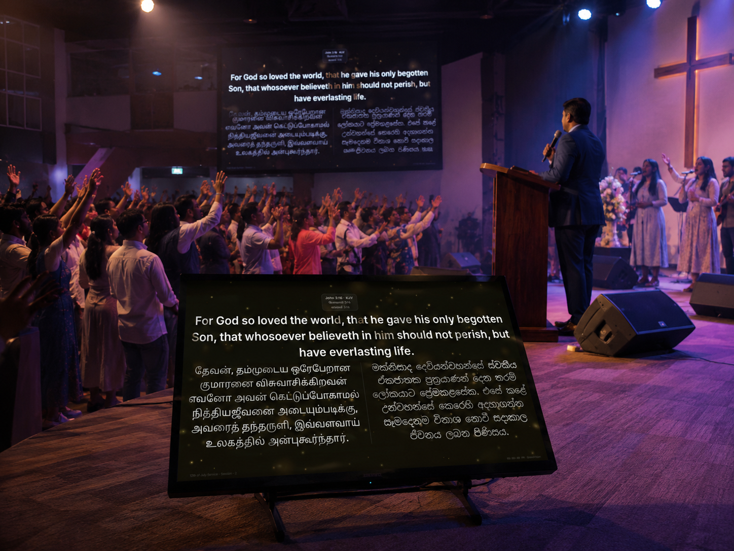 Twin projector screens on either side of a church stage, both showing a matching welcome slide, as the pastor preaches from the pulpit.